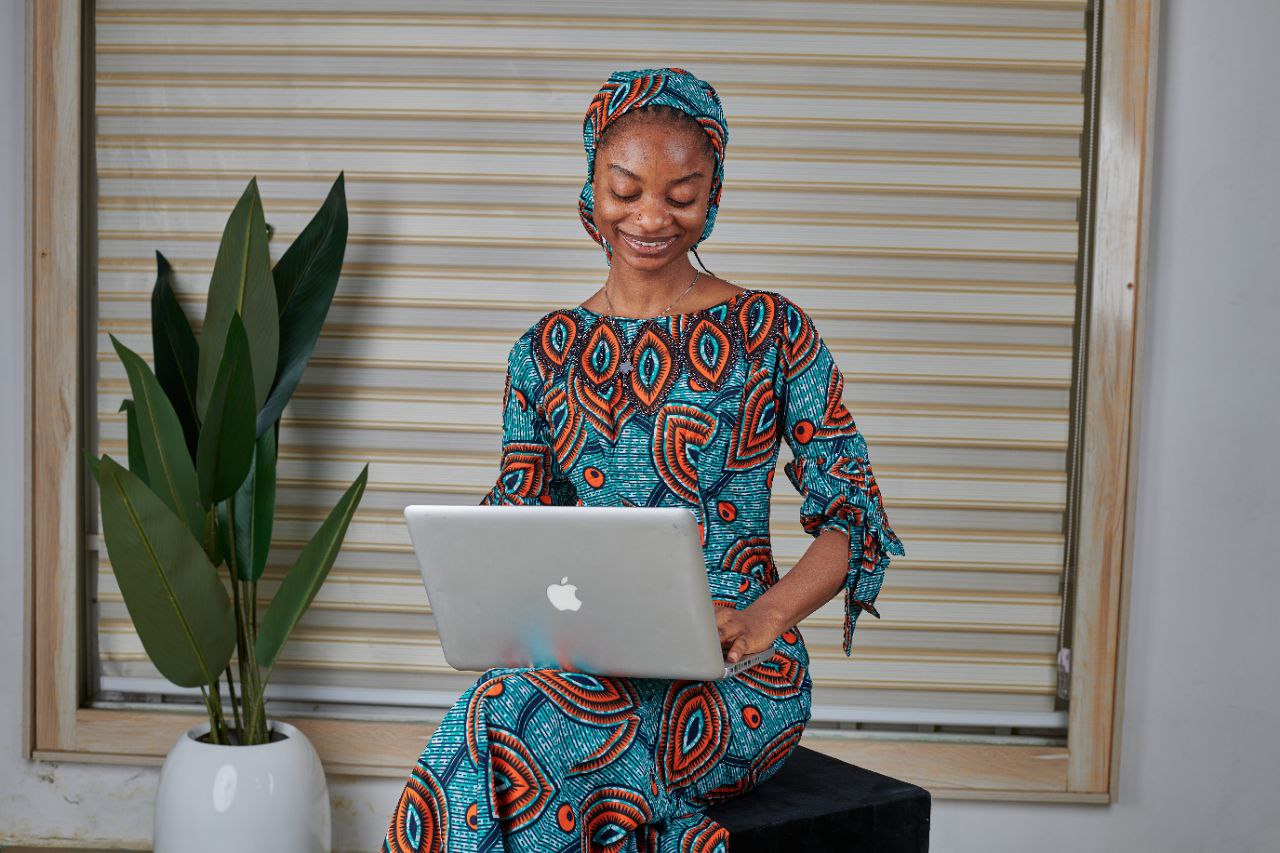 Woman with MacBook on floor